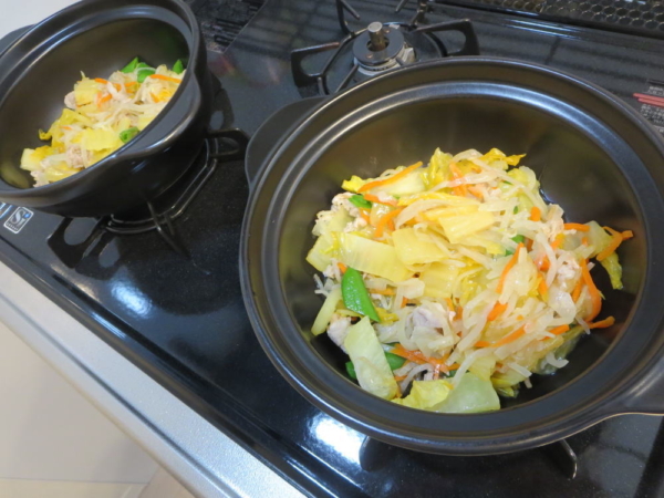 炒めた野菜を土鍋に入れる